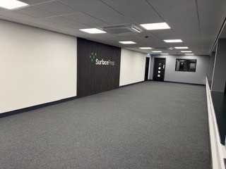 Open-plan office with suspended ceiling and feature wall