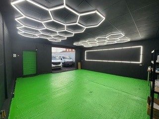 Showroom with black grid ceiling and hexagonal feature lighting